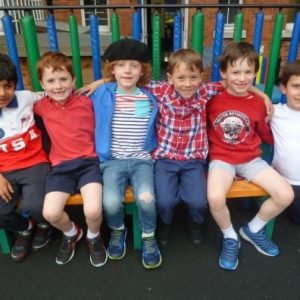 boys sitting next to each other on a bench