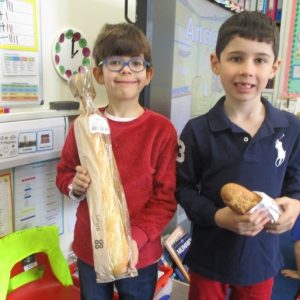 boys holding loaves of bread