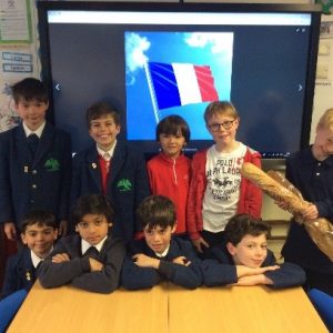 children standing infront of a french flag